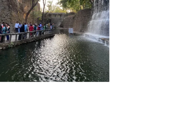 Visitors on the railed walkway beside the waterfall channel in the Rock Garden, Chandigarh