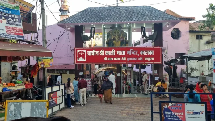 Red signboard reading Prachin Shri Kali Mata Mandir, Kalka over the temple’s entrance gate, with a Ganesh image above it