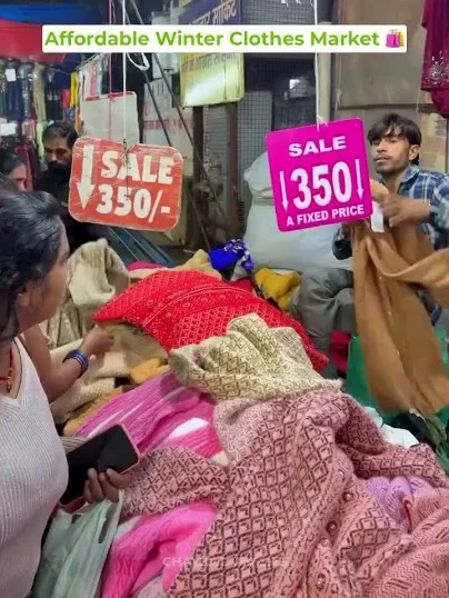 Shawls and warm clothes piled at a Sadar Market stall in Sector 19, Chandigarh, under a ₹350 fixed-price sale sign