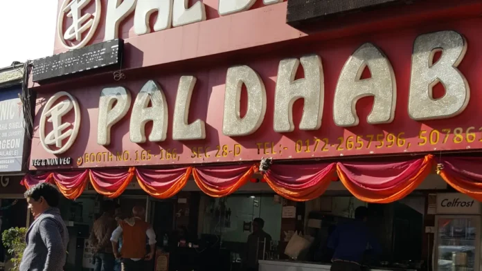 Pal Dhaba signboard reading Booth 165-166, Sector 28-D, above its restaurant front in Chandigarh