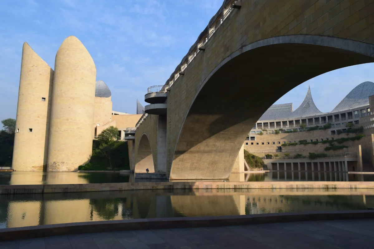 Virasat-E-Khalsa And The Forts Of Anandpur Sahib: Timings, Free Entry And Rules 1 Sandstone-coloured Virasat-e-Khalsa museum with rounded towers, a curved ceremonial bridge arching over a pool and sloping steel-clad roofs in the background
